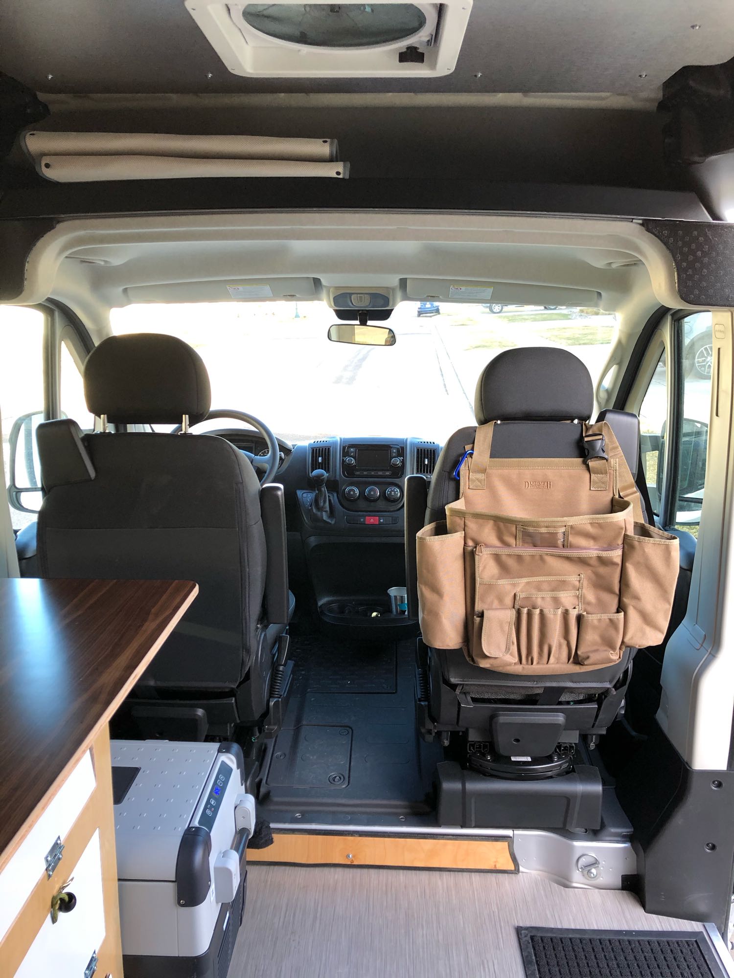 and storage.|Inside an RV rental: a flexible camper van interior with bright green cushions