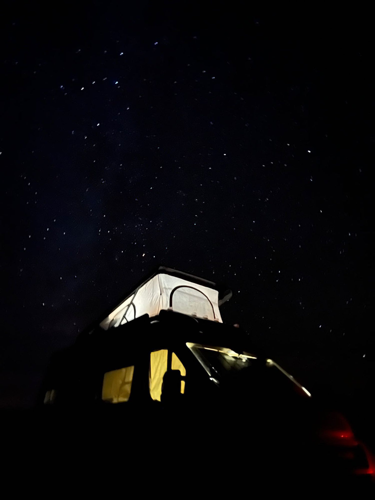 Stargazing from a cozy RV rental: an illuminated pop-top camper van under a dazzling night sky. Perfect for adventure! — photo 2