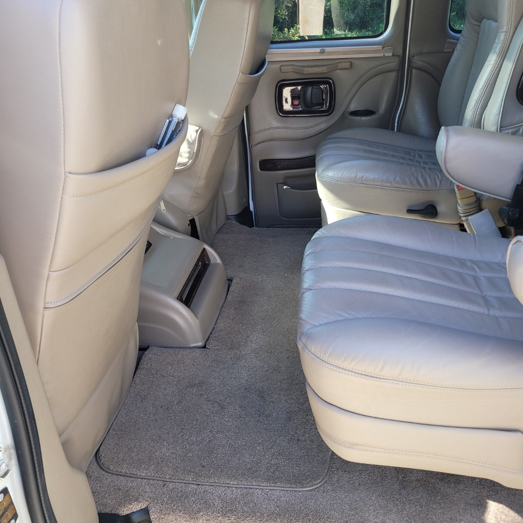 and 12V charger for your road trips.|Spacious RV rental van interior with comfortable seating/bed
