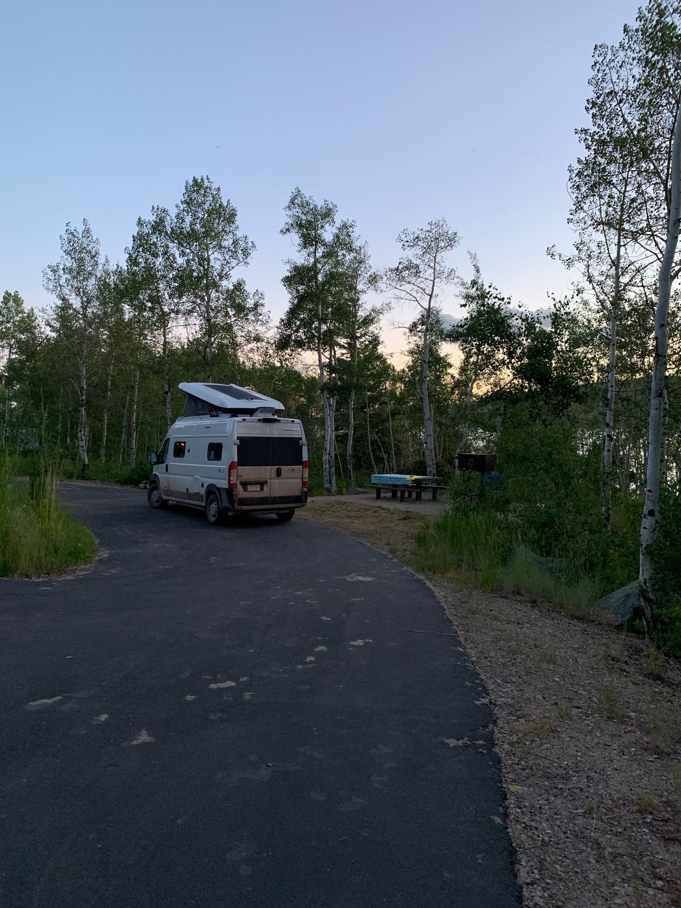 and a broom. Efficient use of space.|RV rental kitchen: a compact two-burner gas stove with a lifted cover — photo 10