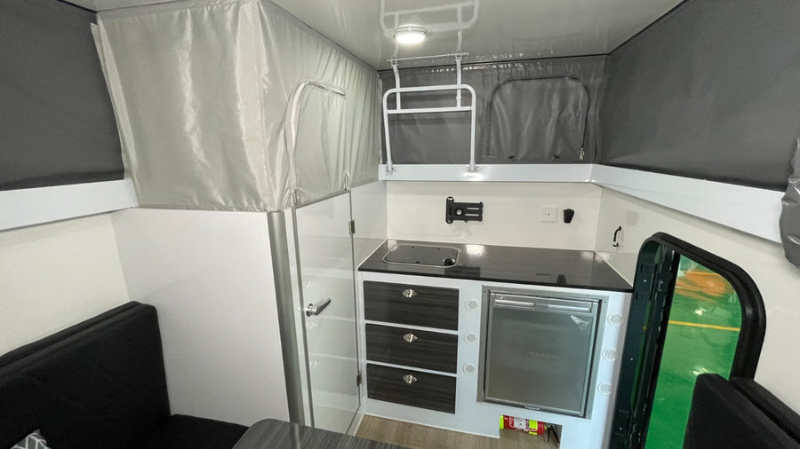 and bunk beds overhead. Ideal for family adventures.|This RV rental floor plan details a compact travel trailer's interior