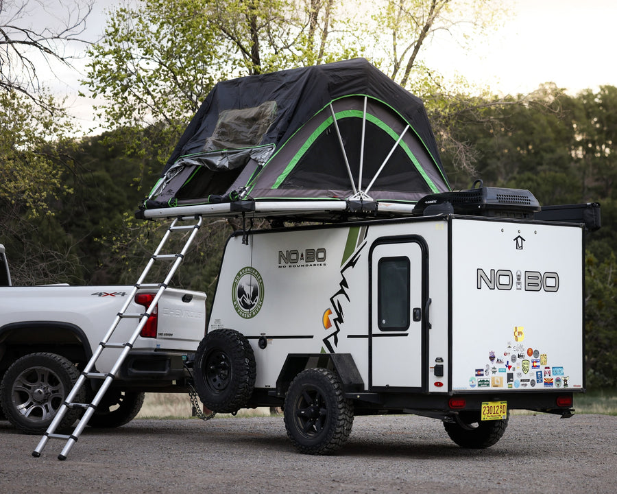 equipped with a roof tent and towed by a 4x4
