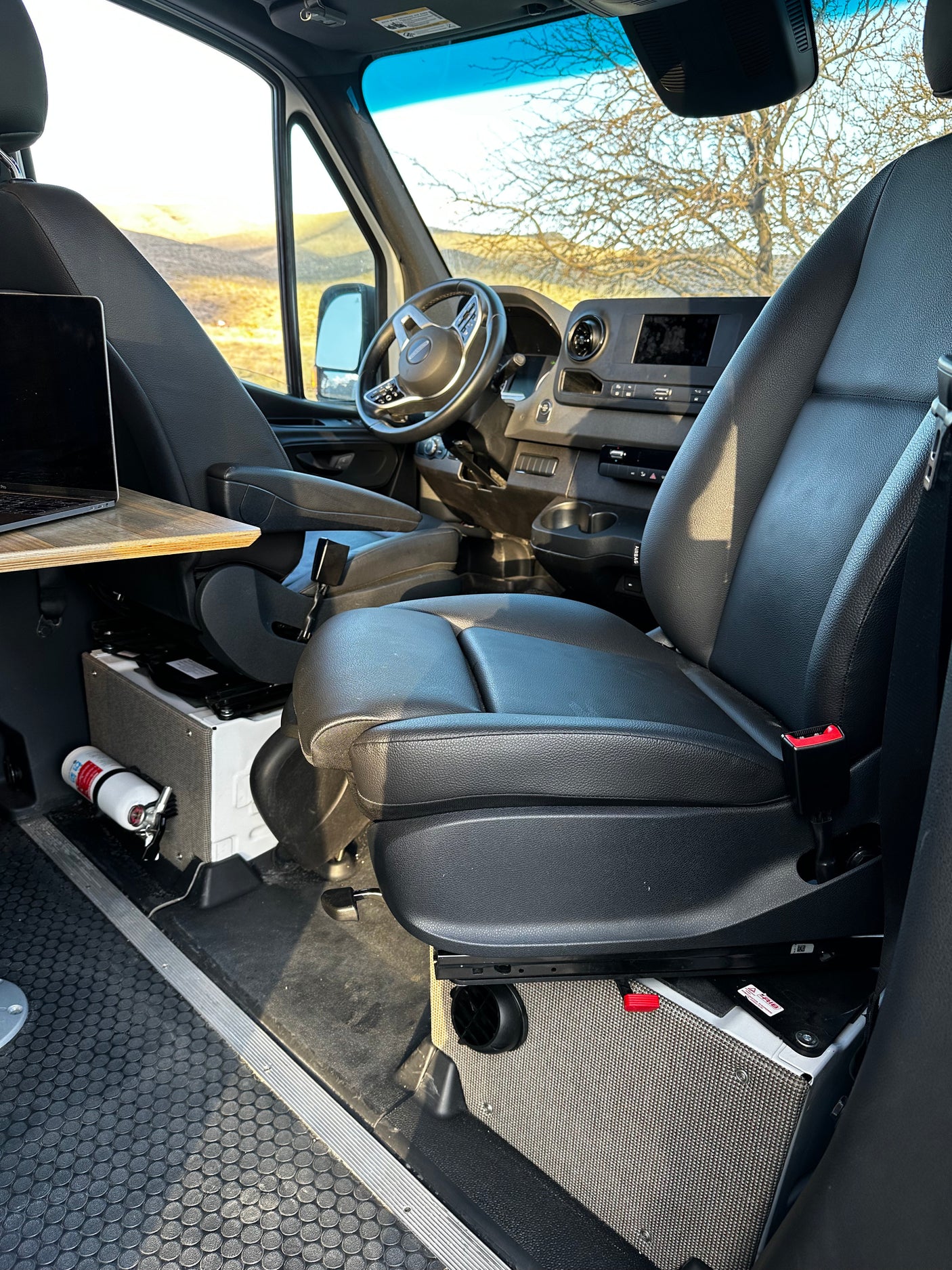 RV rental: Functional camper van interior. Comfy seats, mobile office with laptop, ready for your road trip!