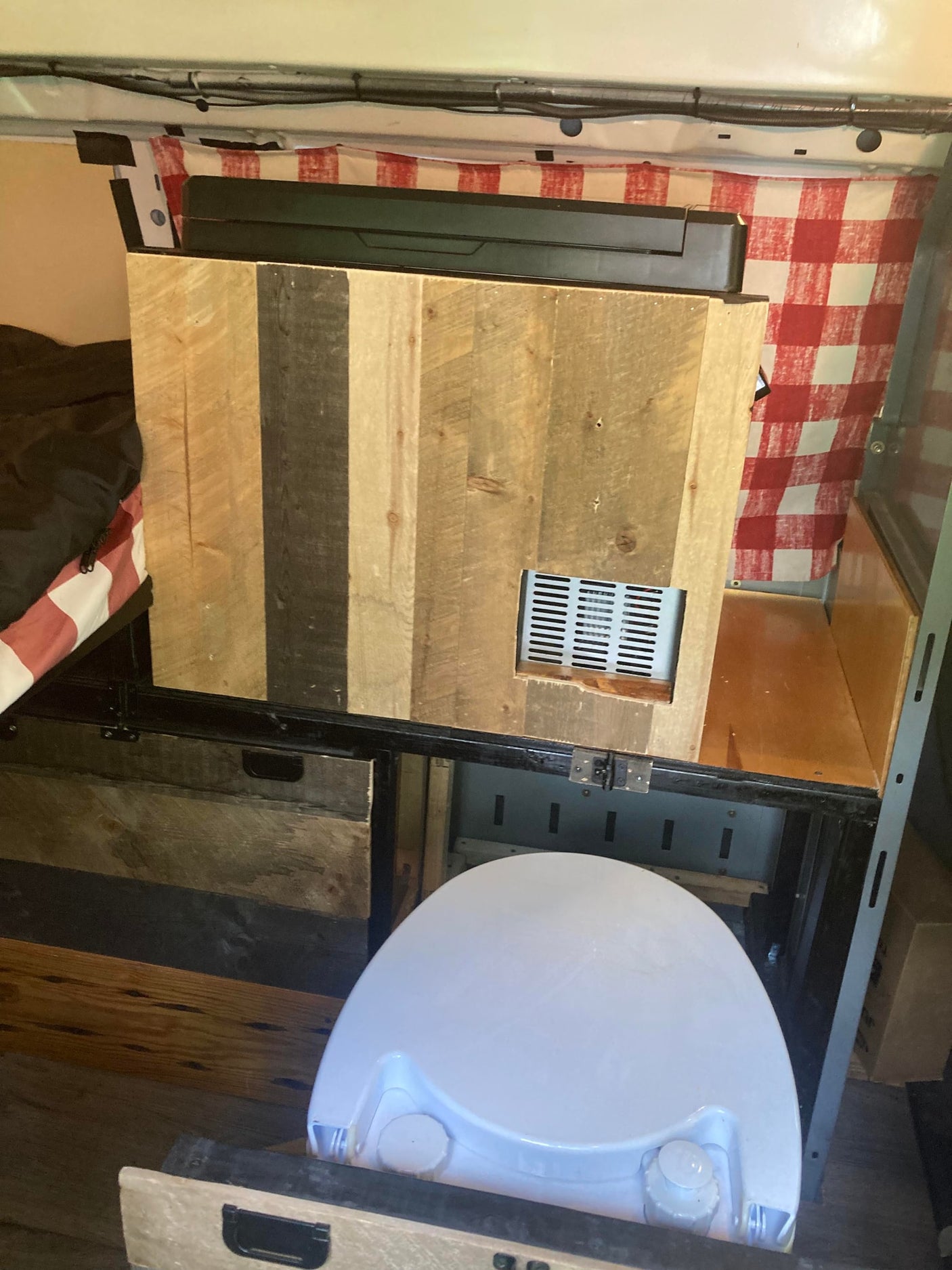 featuring a large insulating windshield cover. Wipers and a side mirror are visible.|Inside a comfy RV rental: view of the dashboard