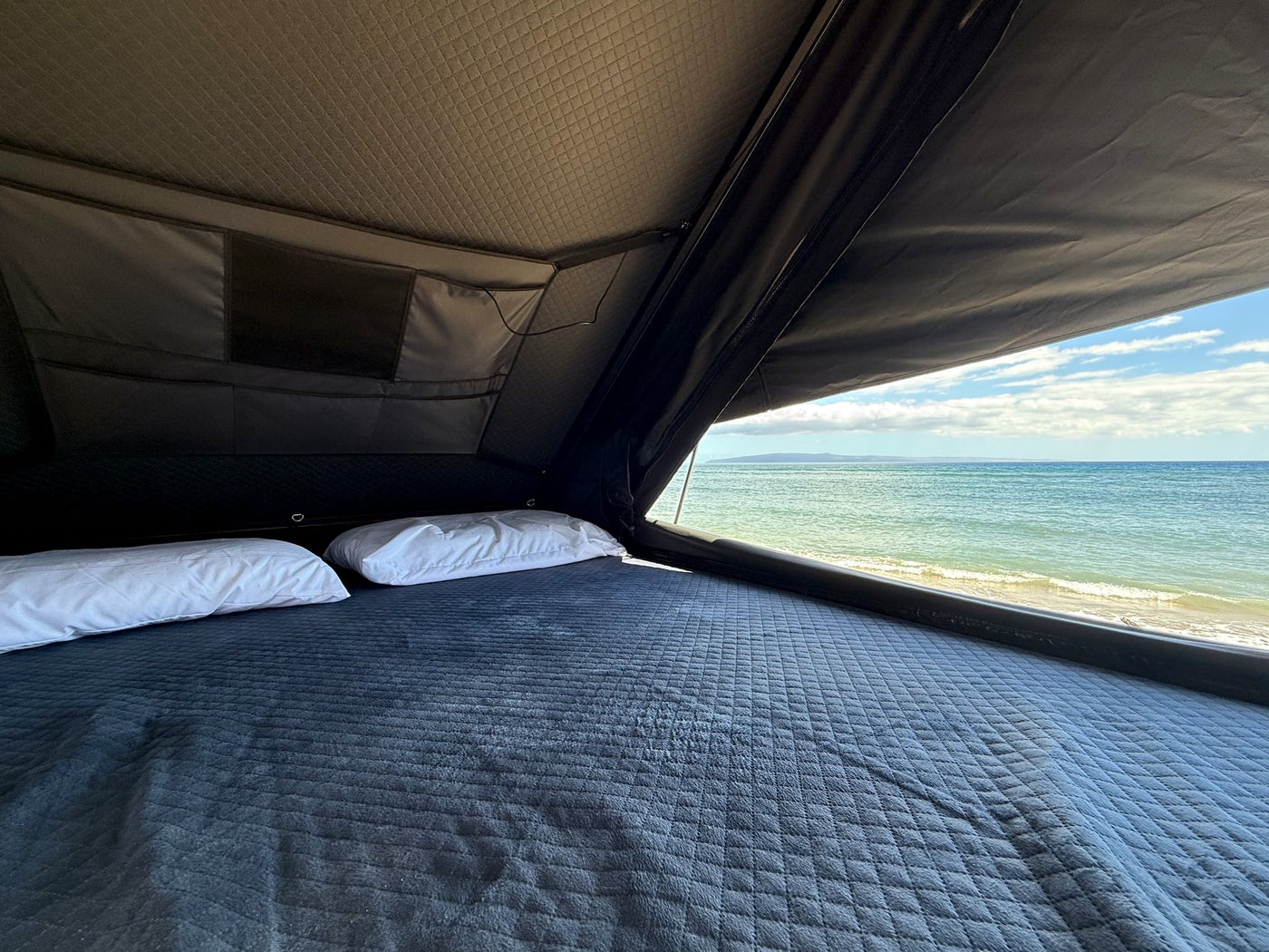 offering comfort and connectivity for rear passengers.|A sleek gray TOPOAK rooftop tent — photo 11
