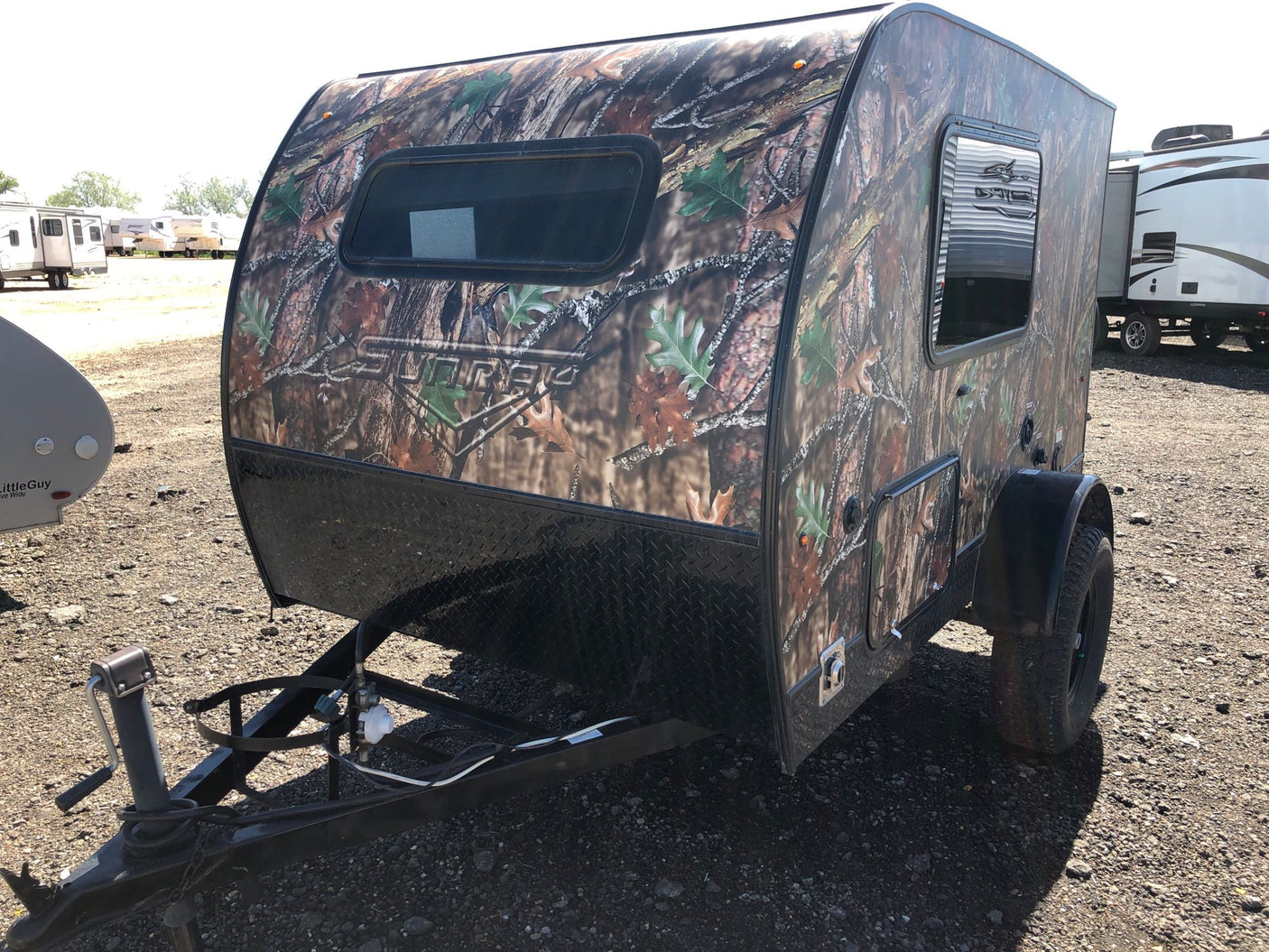 available for RV rental.|Open hatch of an RV rental revealing a compact mobile kitchen with sink