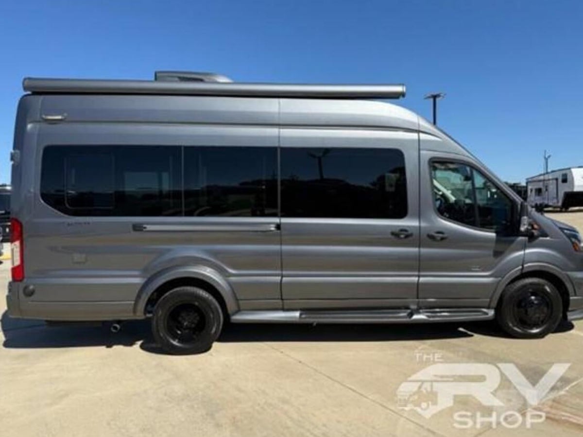 featuring tinted windows and rooftop AC. Ideal for your next travel adventure.|Rear view of a gray Ford Transit camper van — photo 5