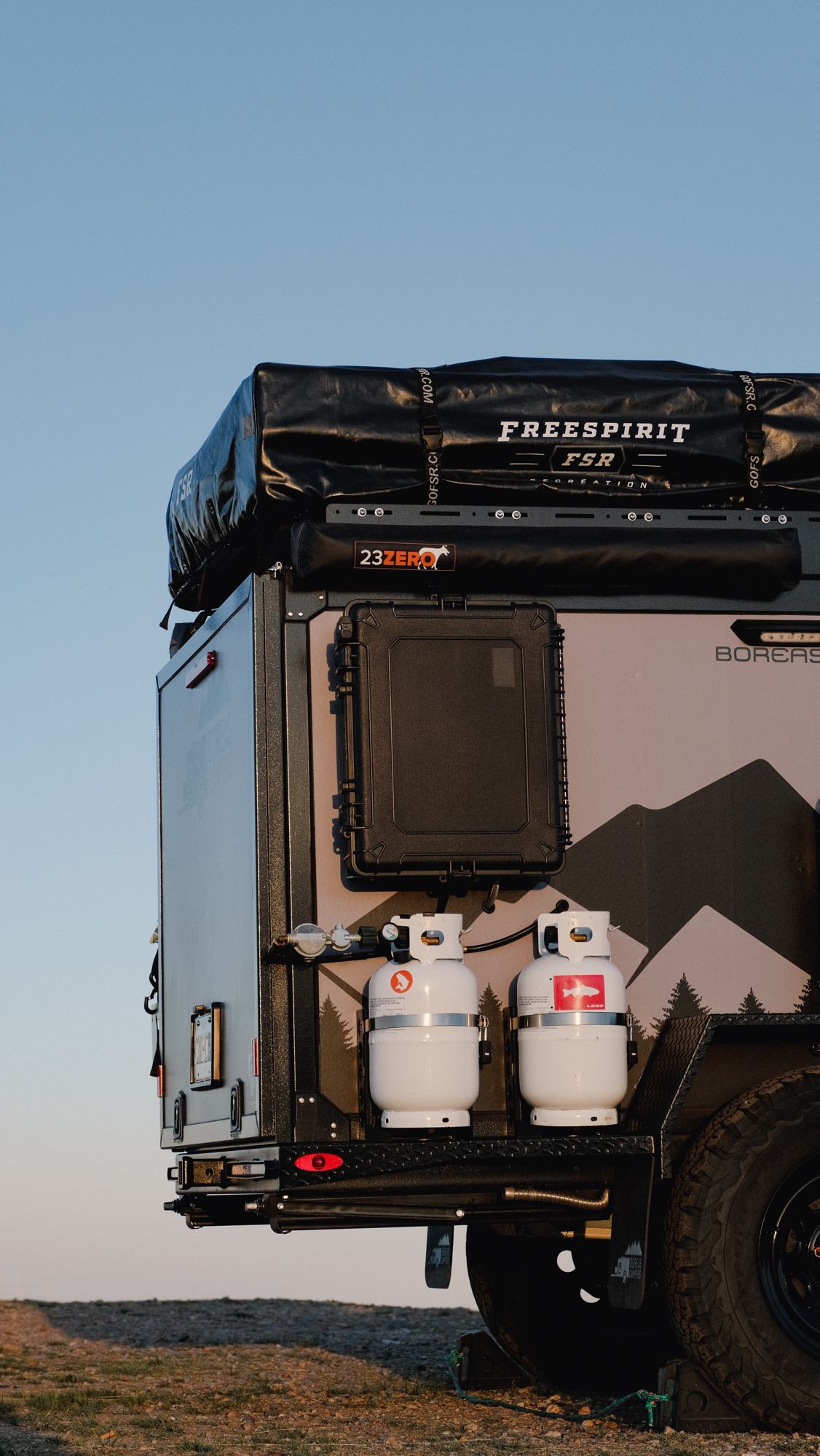 and storage for your outdoor adventures.|Rear view of an open overland camper trailer's outdoor kitchen
