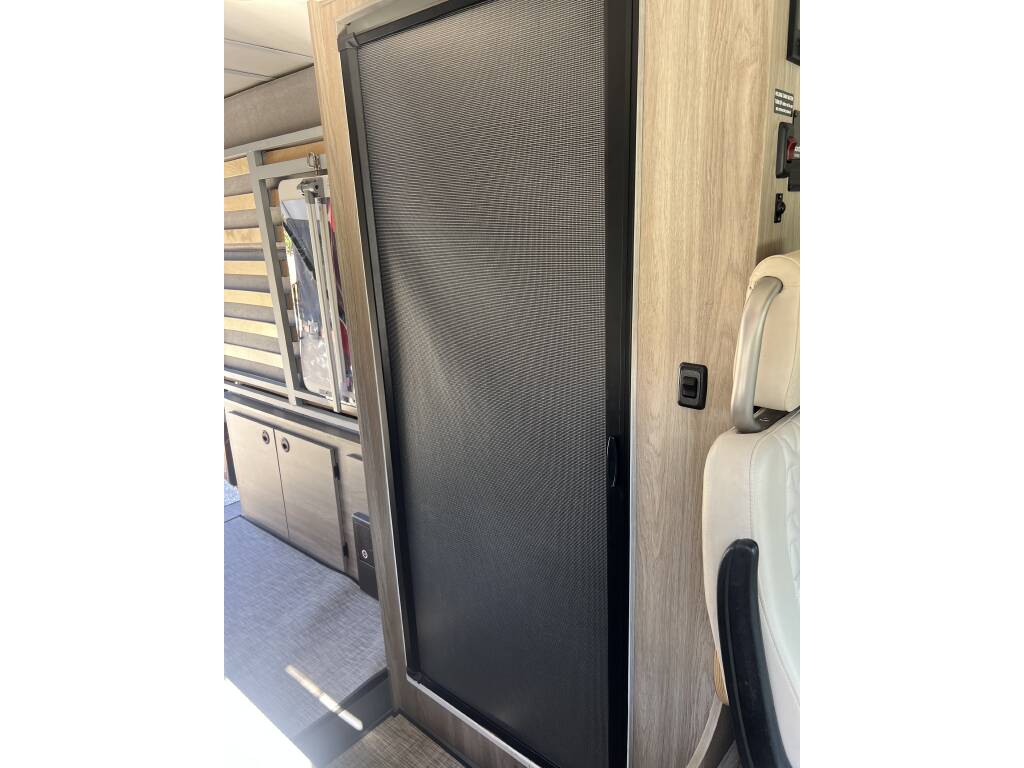 and rear doors.|Spacious rv rental interior: dining area with white seats