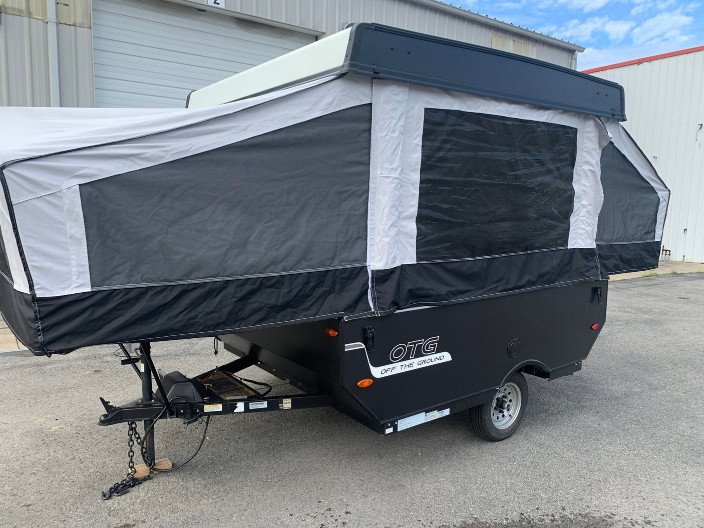 Black and white OTG pop-up camper RV rental, ideal for camping & travel. Ready for your next outdoor adventure.