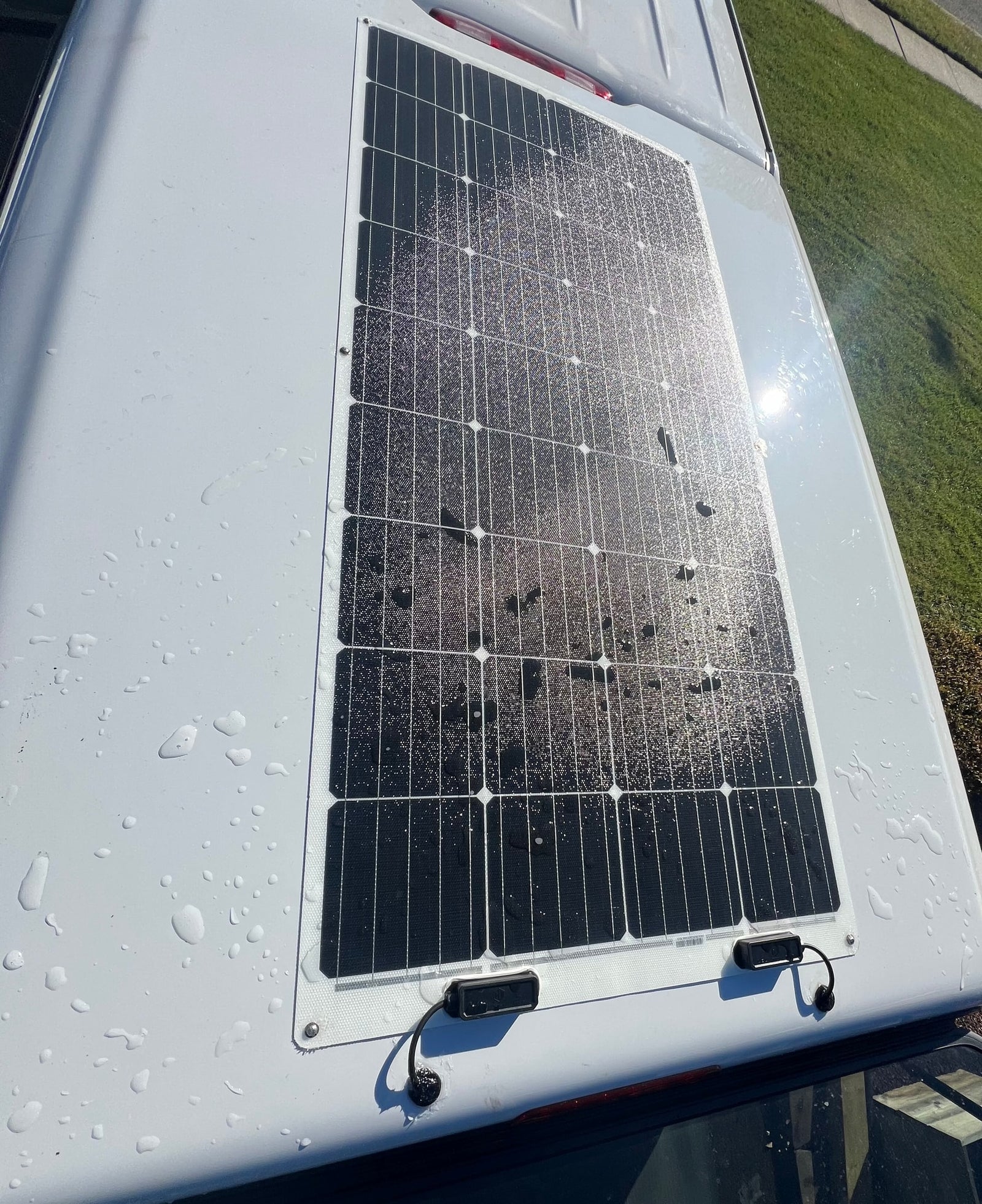This RV rental features a rooftop solar panel, seen here sparkling with water droplets after a recent wash.