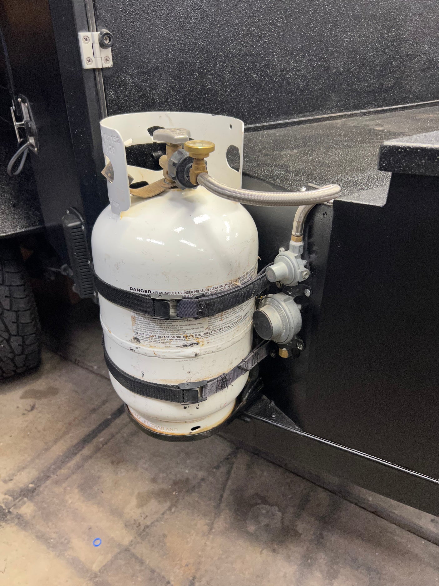 LP-gas cylinder securely mounted on an RV rental, perfect for outdoor cooking.