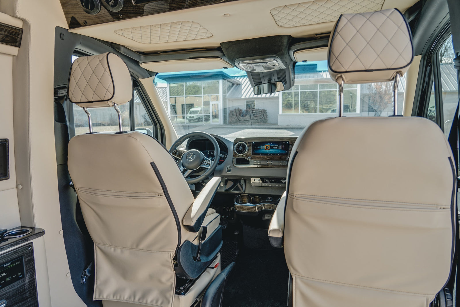 and privacy blinds.|Inside a modern **rv rental** showing the driver's dashboard and a digital control panel for lighting