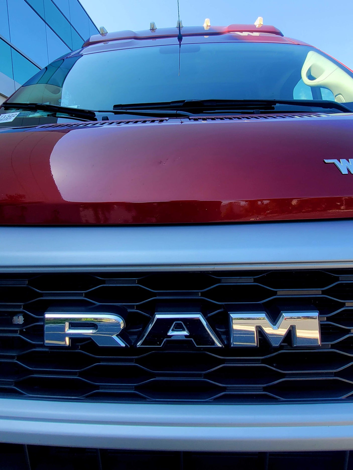 Front view of a red Ram heavy-duty truck, its RAM grille prominent, suitable for rv rental.