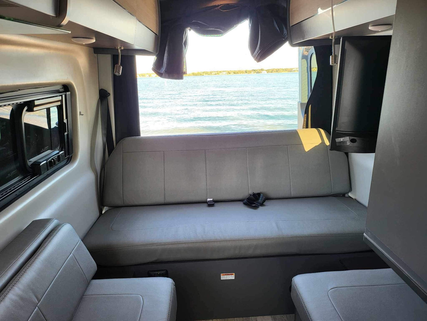 RV rental: Rear bench seat offers panoramic lake views from inside the comfortable camper van.