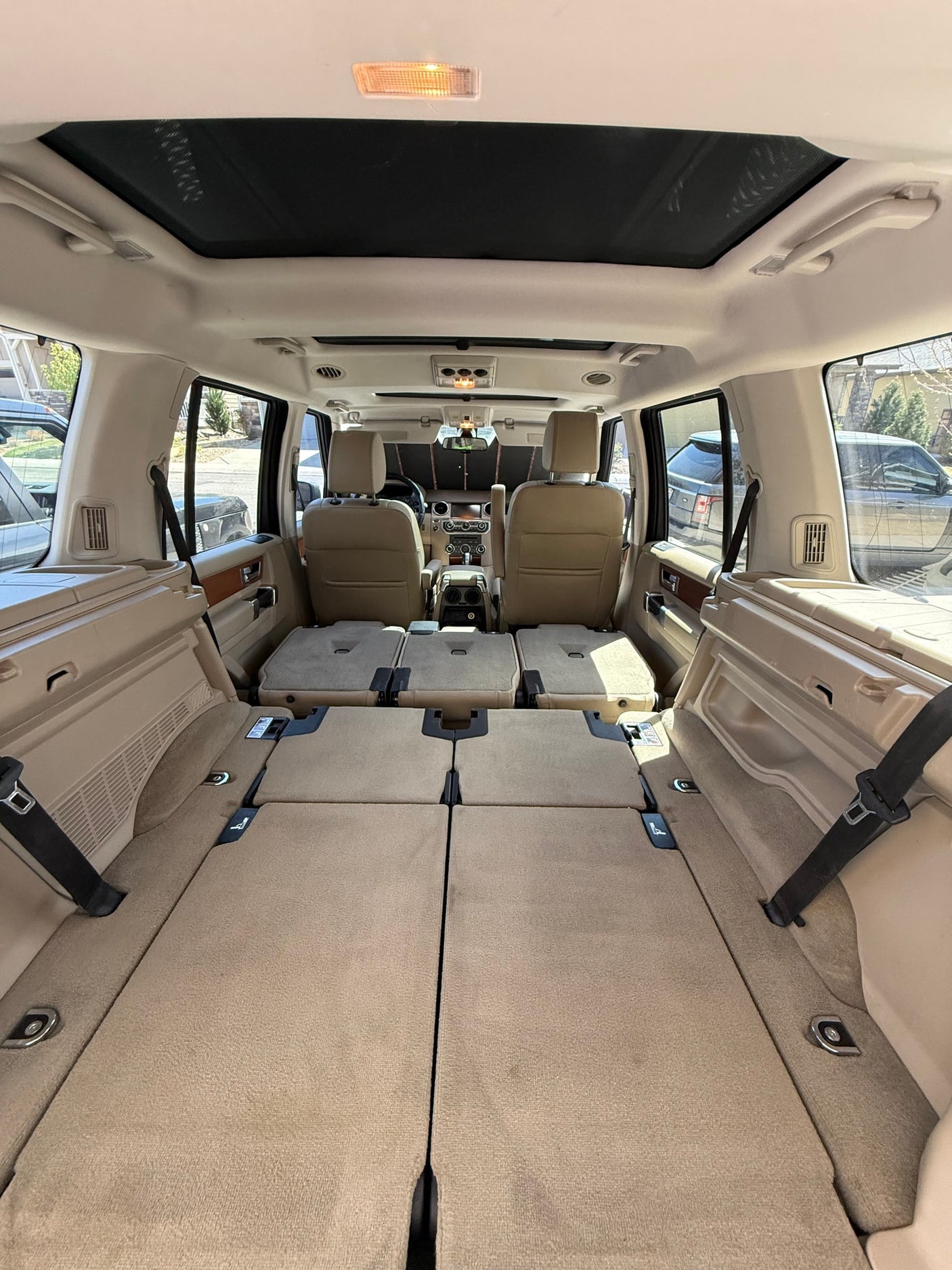 Spacious SUV interior with folded rear seats creating ample cargo, great for an RV rental alternative or travel.
