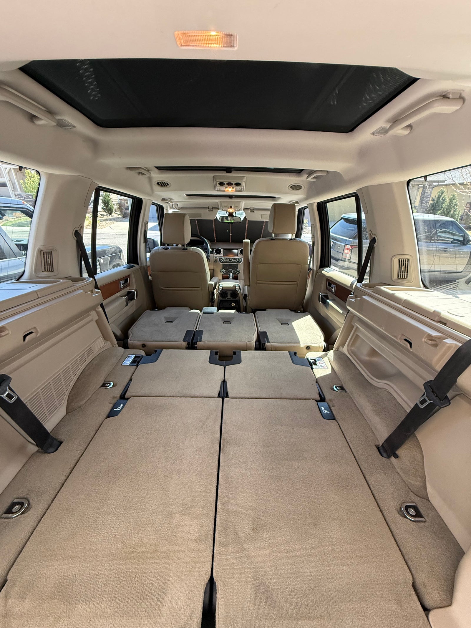 Spacious SUV interior with folded rear seats creating ample cargo, great for an RV rental alternative or travel.