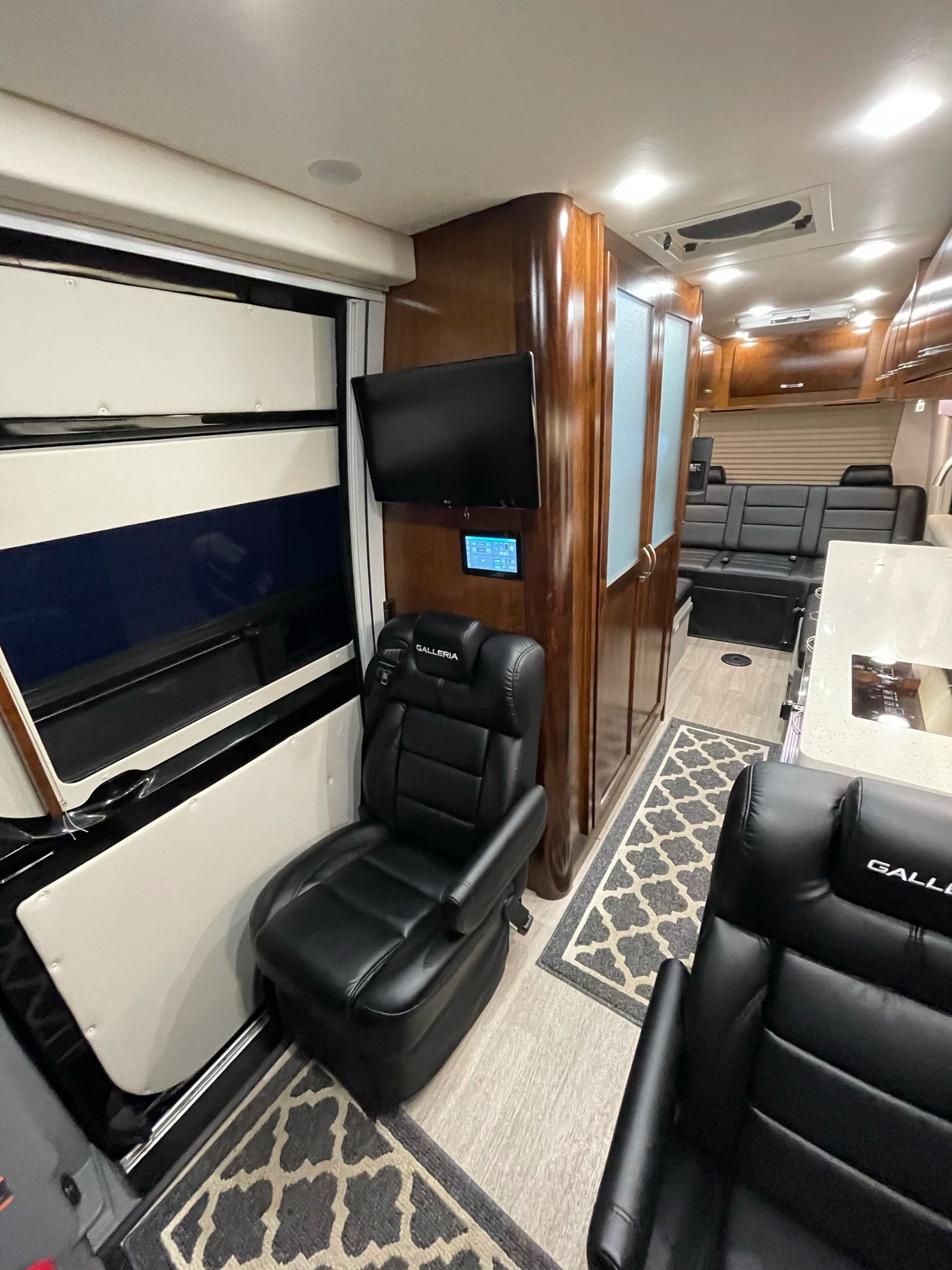 ready for your road trips.|This RV rental's modern interior showcases a U-shaped black leather lounge