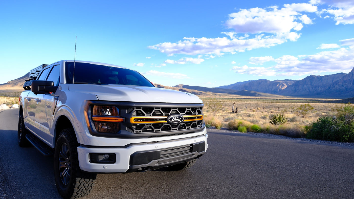 Explore scenic desert trails with this rugged Ford F-150 Tremor pickup, ideal for adventure rv rental. Mountains in background. — photo 8