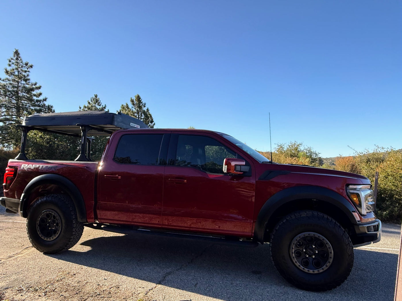 ideal for gear or towing on your next RV rental adventure.|Red Ford F-150 Raptor pickup with bed rack — photo 13