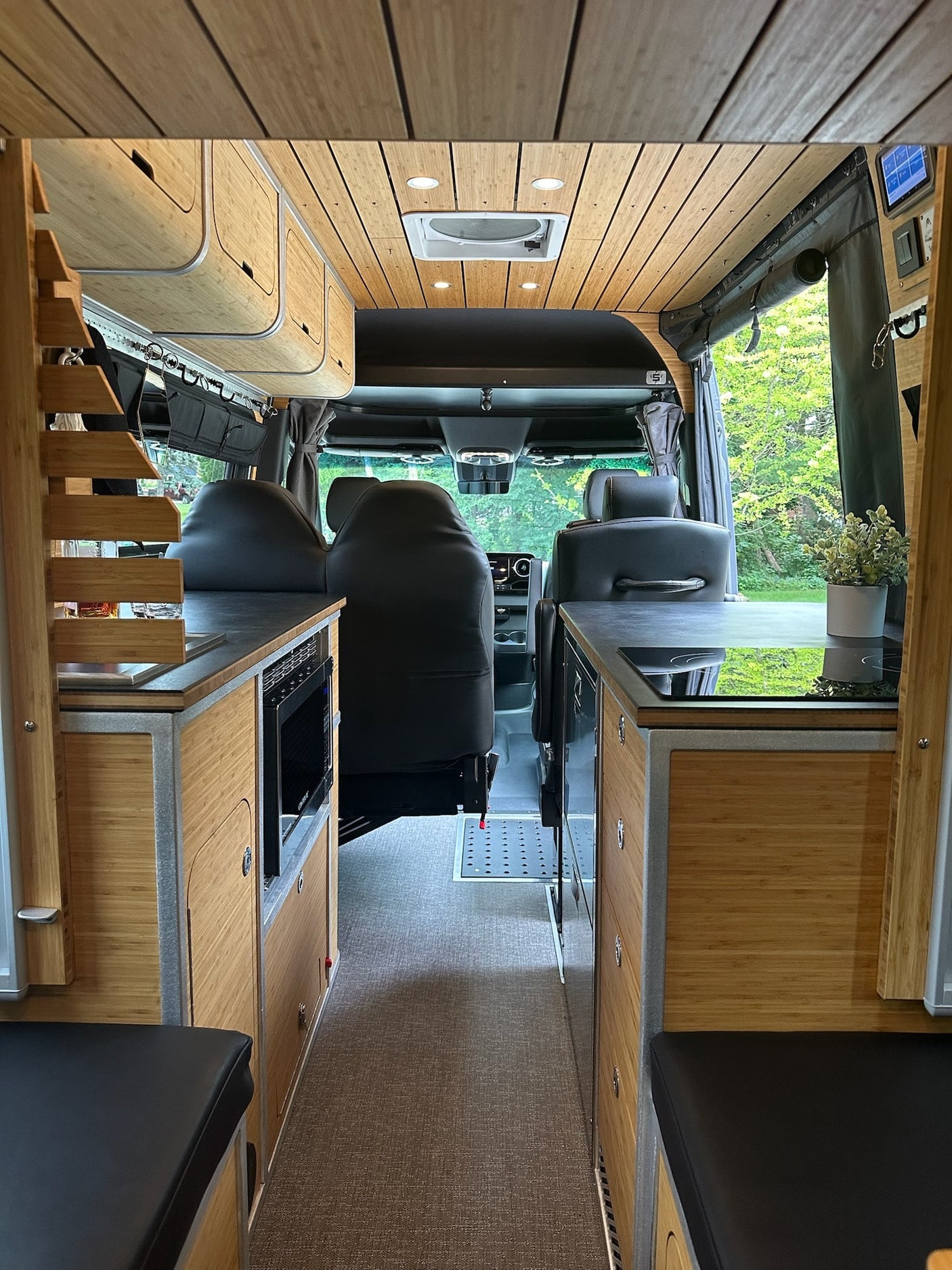 and bamboo cabinetry. Includes liquor setup & seating.|Luxury RV rental kitchen: bamboo cabinetry