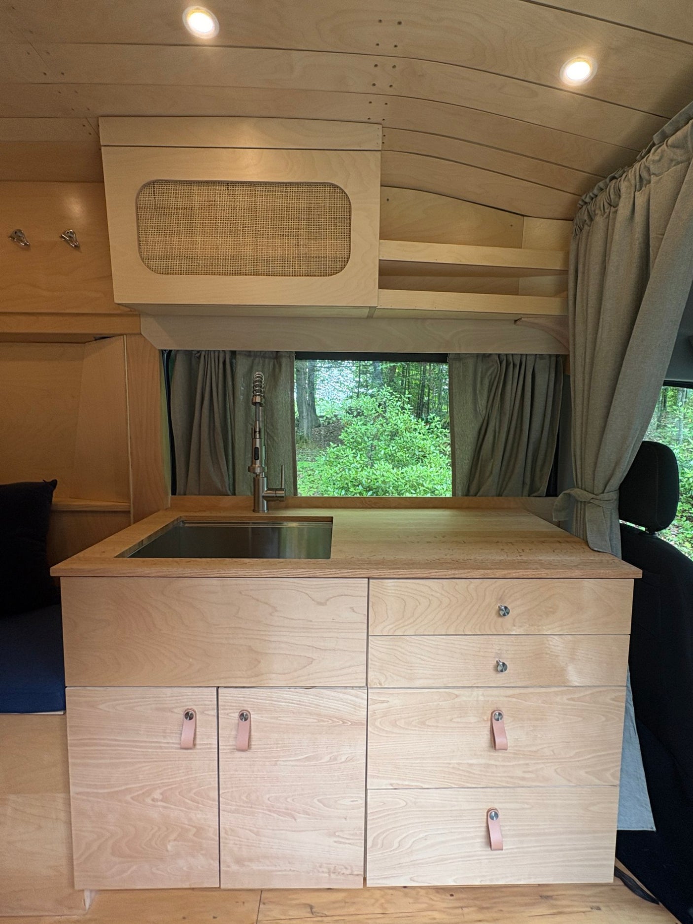 and custom seating.|This cozy RV rental interior features natural wood paneling