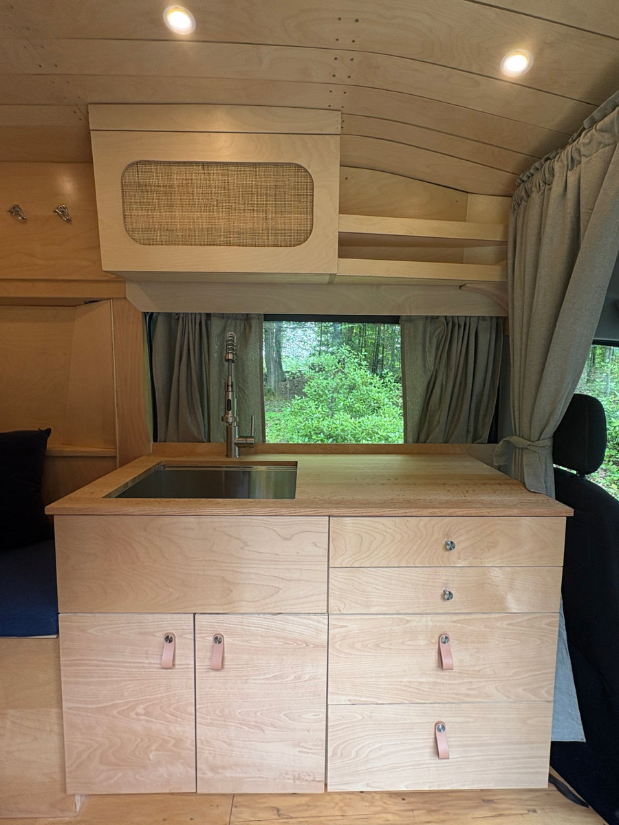 and custom seating.|This cozy RV rental interior features natural wood paneling