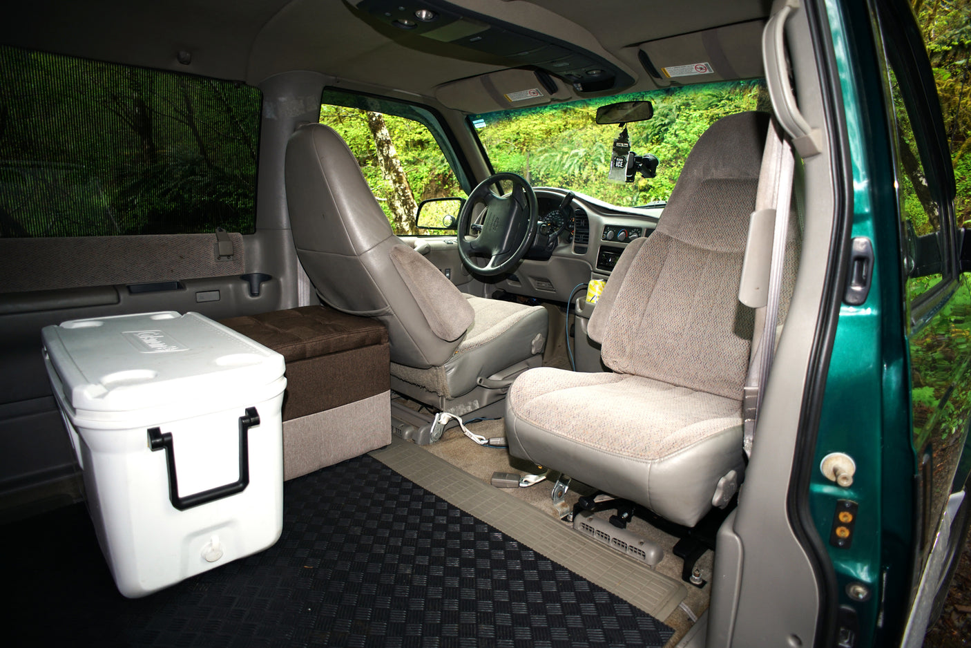 **RV rental interior:** This camper van offers comfortable seating, a cooler, and ample storage for your road trip.