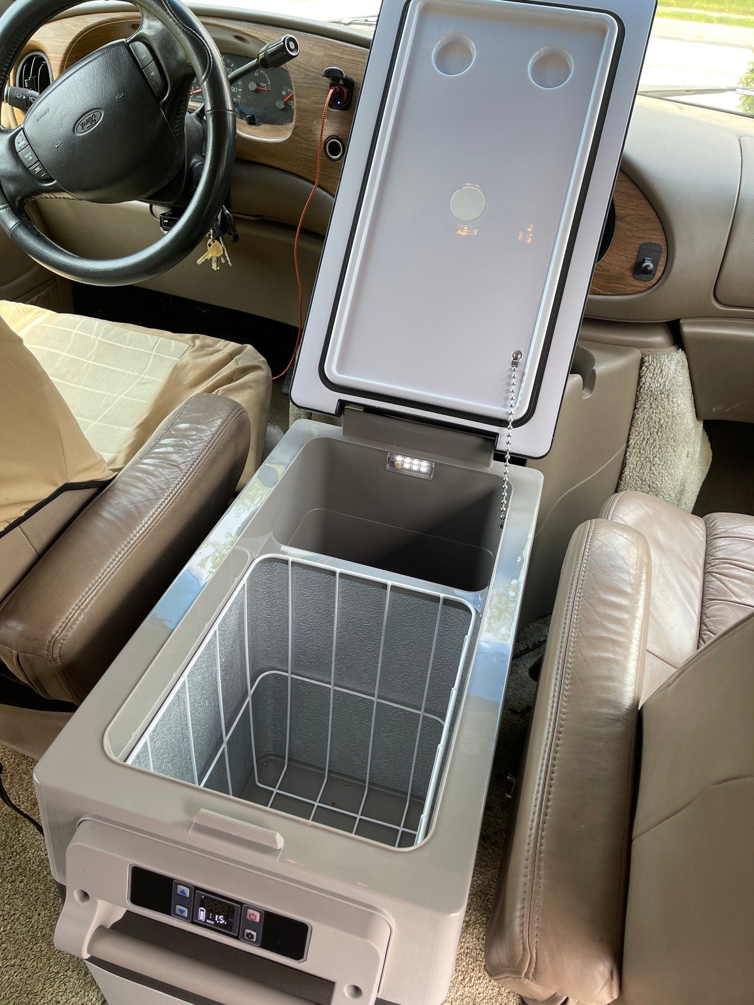 ready for convenient travel.|**RV rental** power setup: 750-watt inverter & battery box on the floor