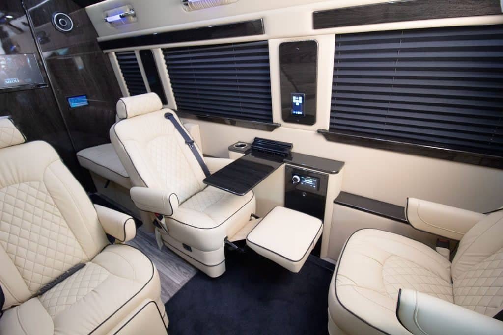 and steering wheel.|Spacious luxury interior of a custom van