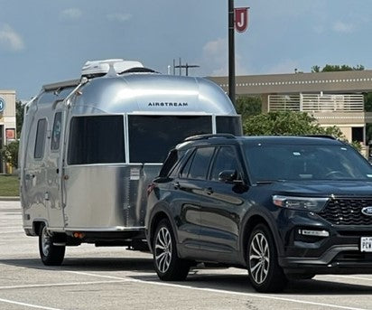 Black SUV towing a silver Airstream travel trailer, perfect for an RV rental vacation. — photo 10