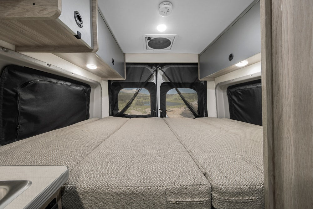 living space & storage.|Experience an RV rental: a compact kitchen area with sink