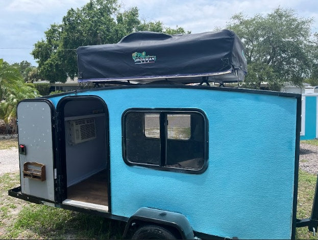 Compact blue teardrop travel trailer