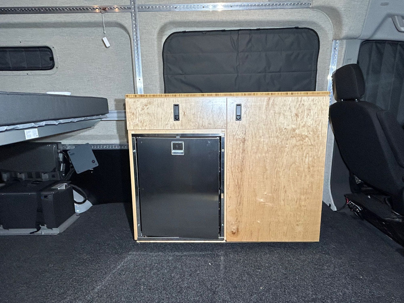 and insulated doors.|RV rental power setup: Ecoflow portable power station with battery modules provides off-grid energy for your camper van.|An RV rental interior featuring a raised bed platform — photo 5