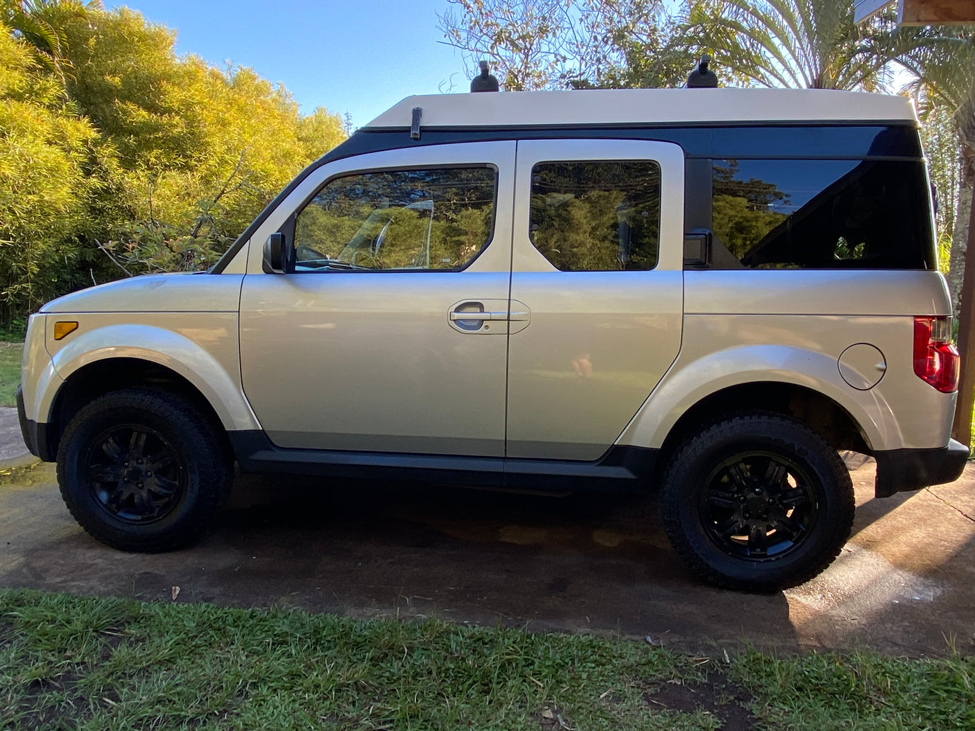 Light Honda Element SUV converted to pop-top RV rental for outdoor adventures.