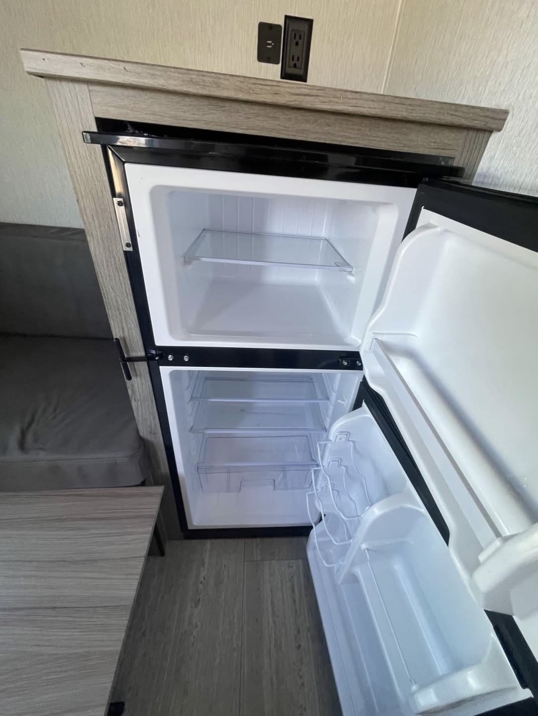 and controls.|Experience nature with this modern rv rental. A sleek black and silver travel trailer with an extended awning