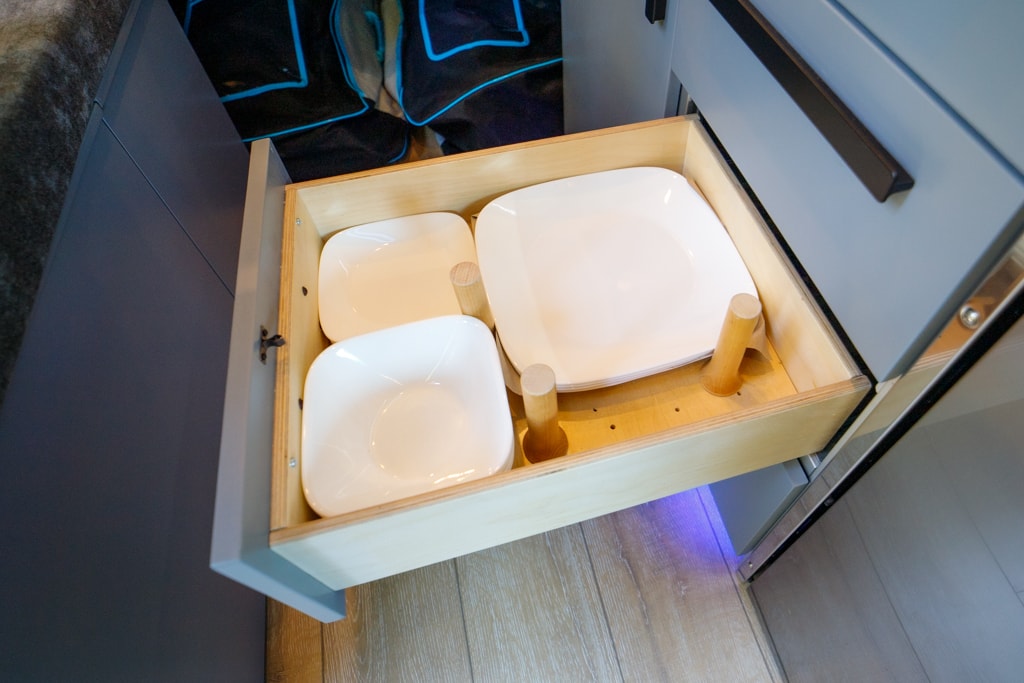 featuring a kitchen and bed area.|Spacious RV rental interior: modern camper van with a cozy bed — photo 20