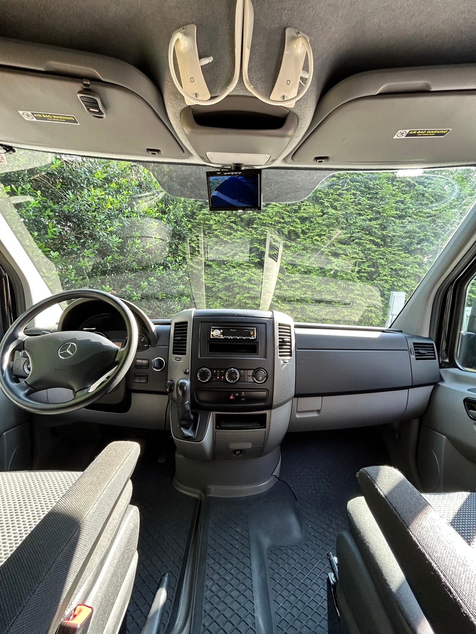 and bed. Flowers & candle add charm.|Inside a versatile RV rental camper van: Features a compact dining area with table