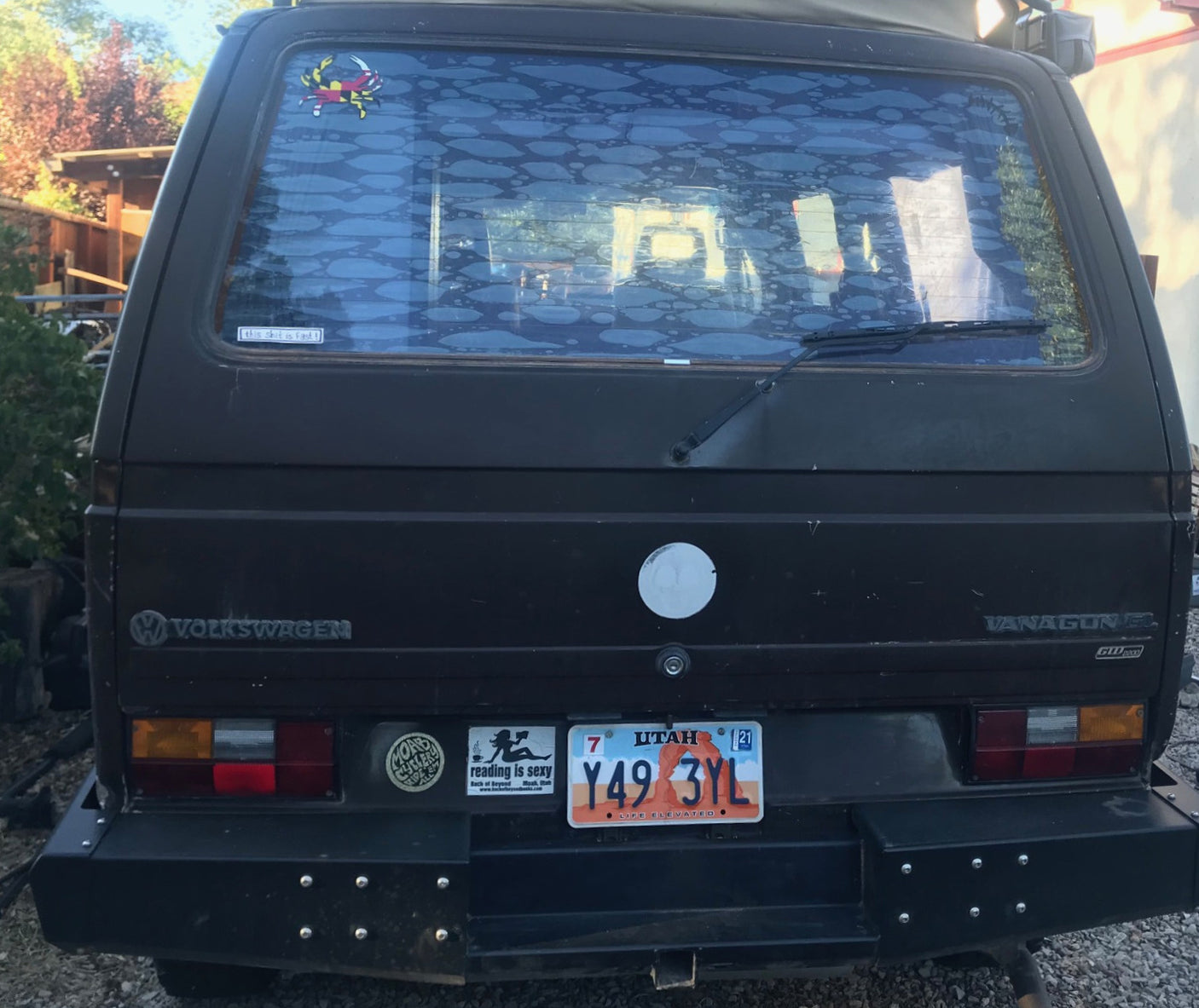 showing fluffy front seats and a built-in kitchen unit on the left.|Westfalia RV rental kitchen setup: gas stove