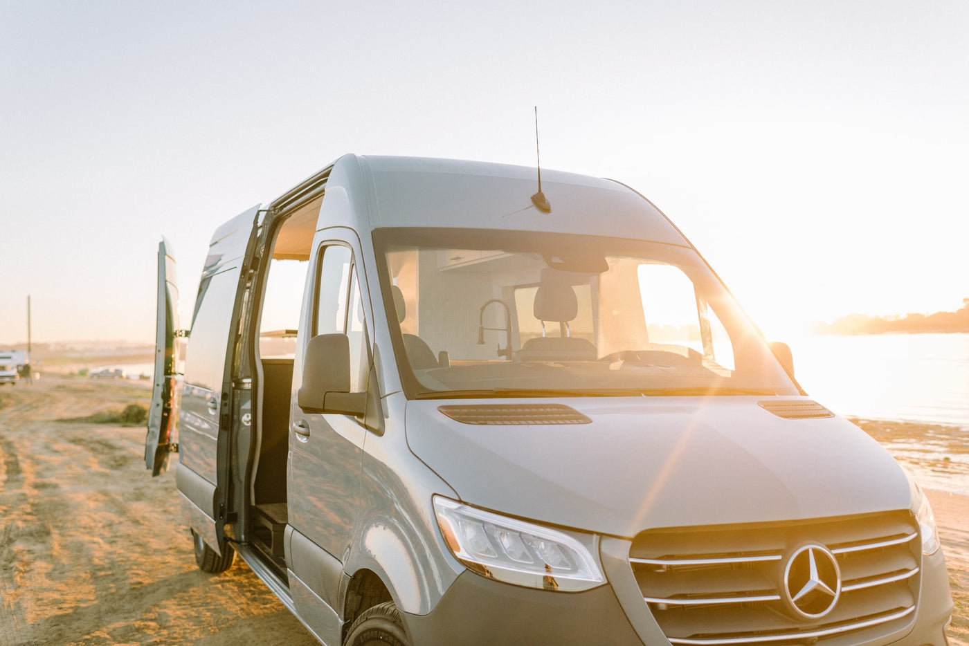 RV rental adventure starts! Grey Mercedes-Benz Sprinter camper van by the water at sunrise. Perfect for outdoor travel. — photo 20