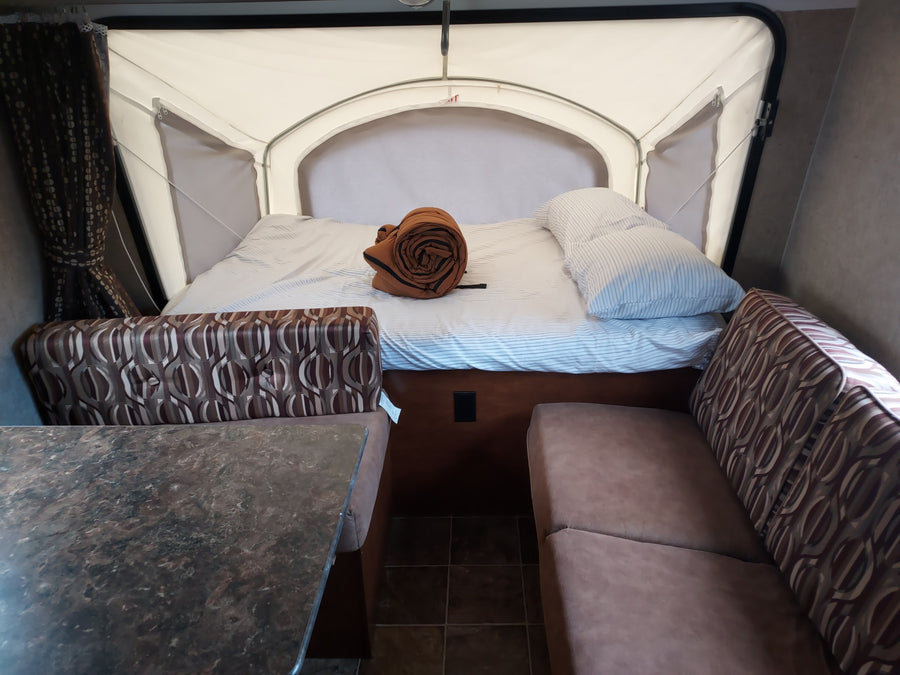 |Spacious RV rental interior with a cozy pop-out bed
