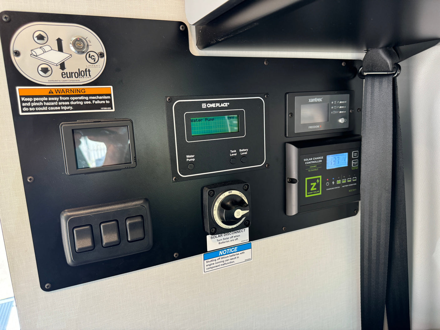 RV rental control panel: Euroloft bed lift, water pump, Zamp solar charge, and battery status for utility management.