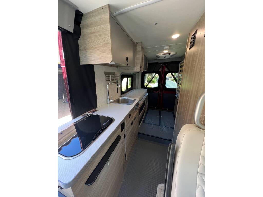 and cockpit.|View inside an RV rental shows a modern kitchenette