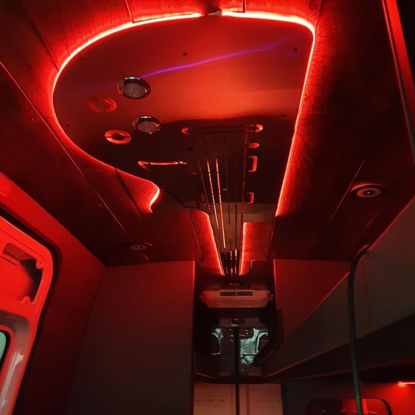 and entertainment screens.|RV rental's custom interior: black diamond-quilted seating
