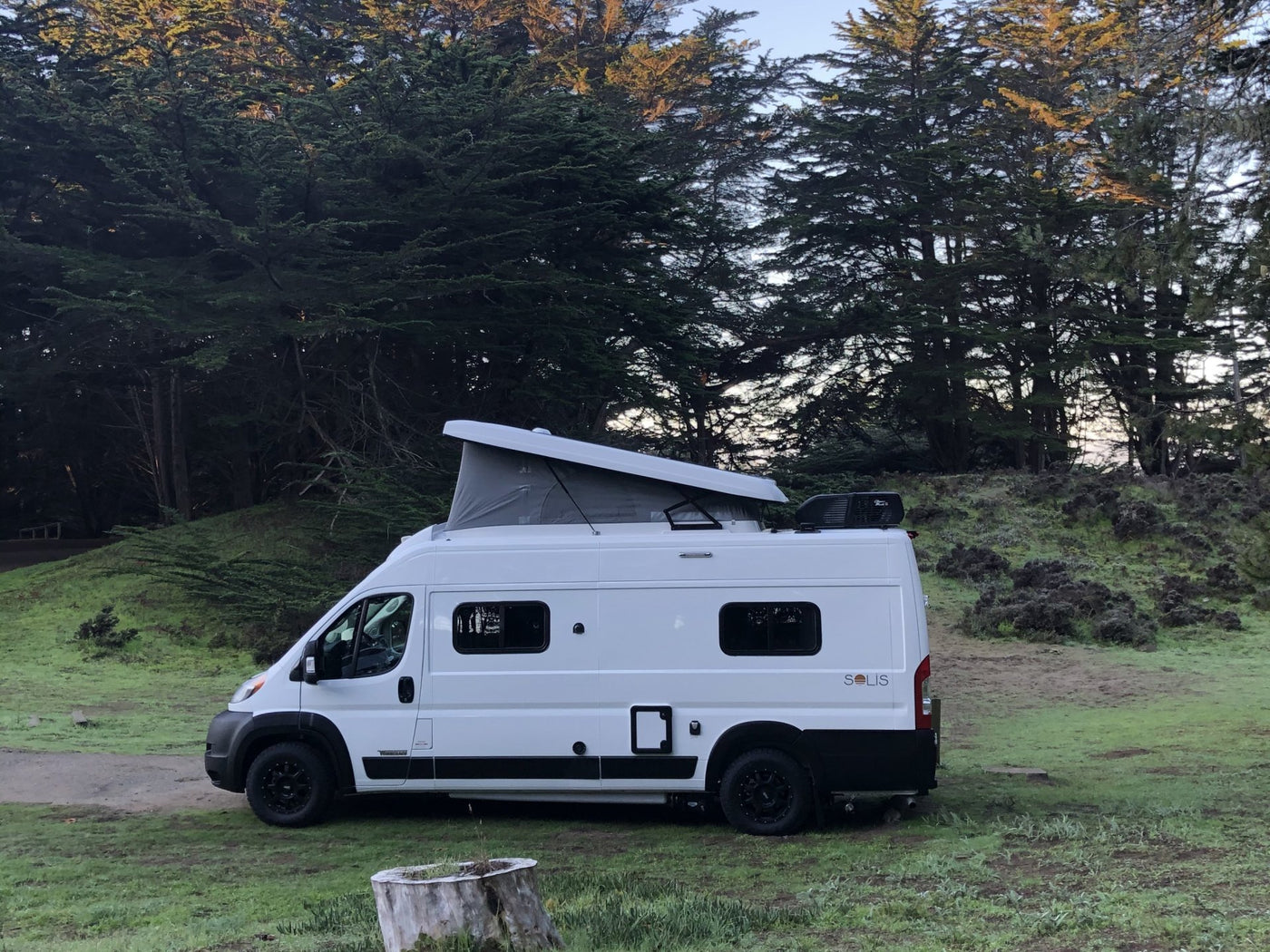 This white pop-top camper van — photo 1