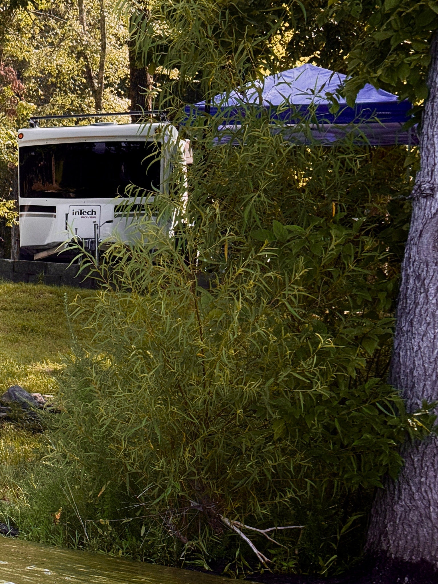 featuring ROVER branding & marble counters.|RV rental: Compact interior with a white portable toilet