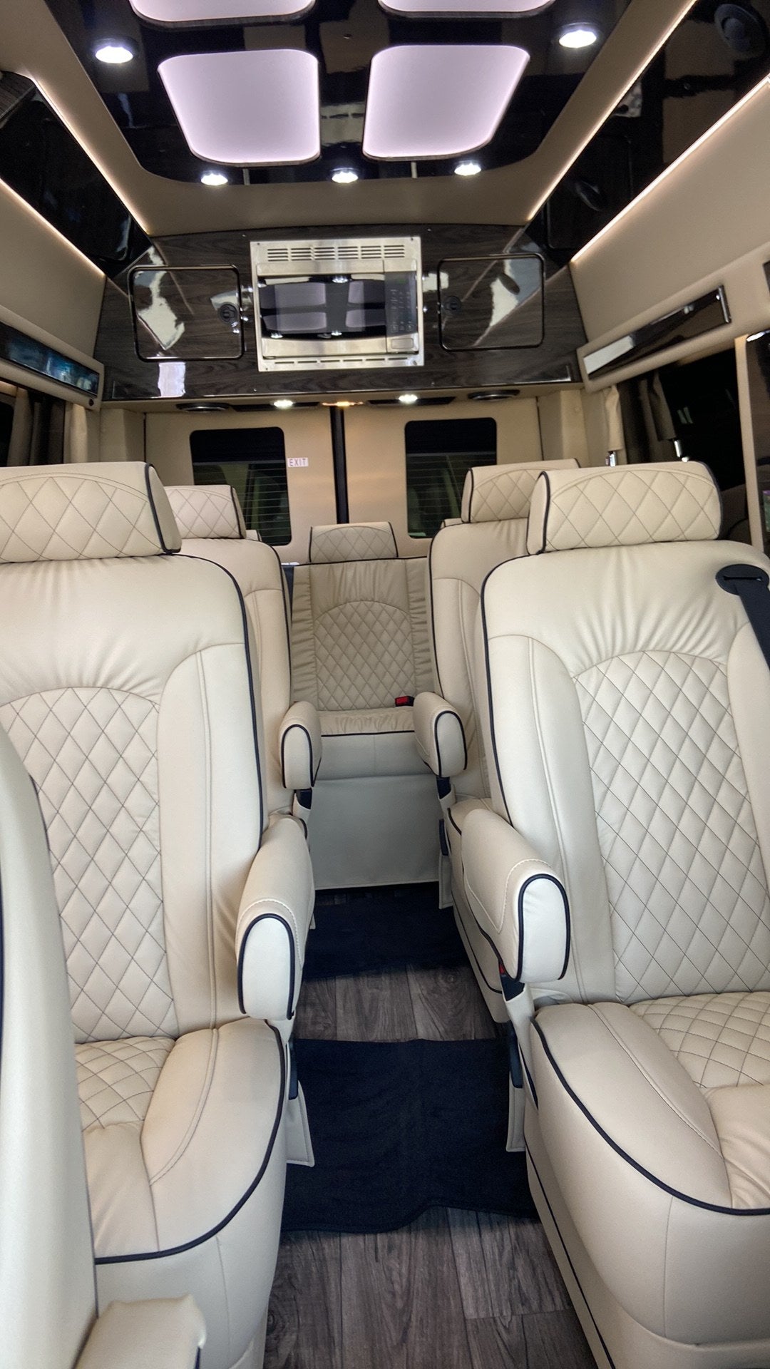 and a comfortable design for your journey.|Rear view of a luxury black RV rental van with open doors