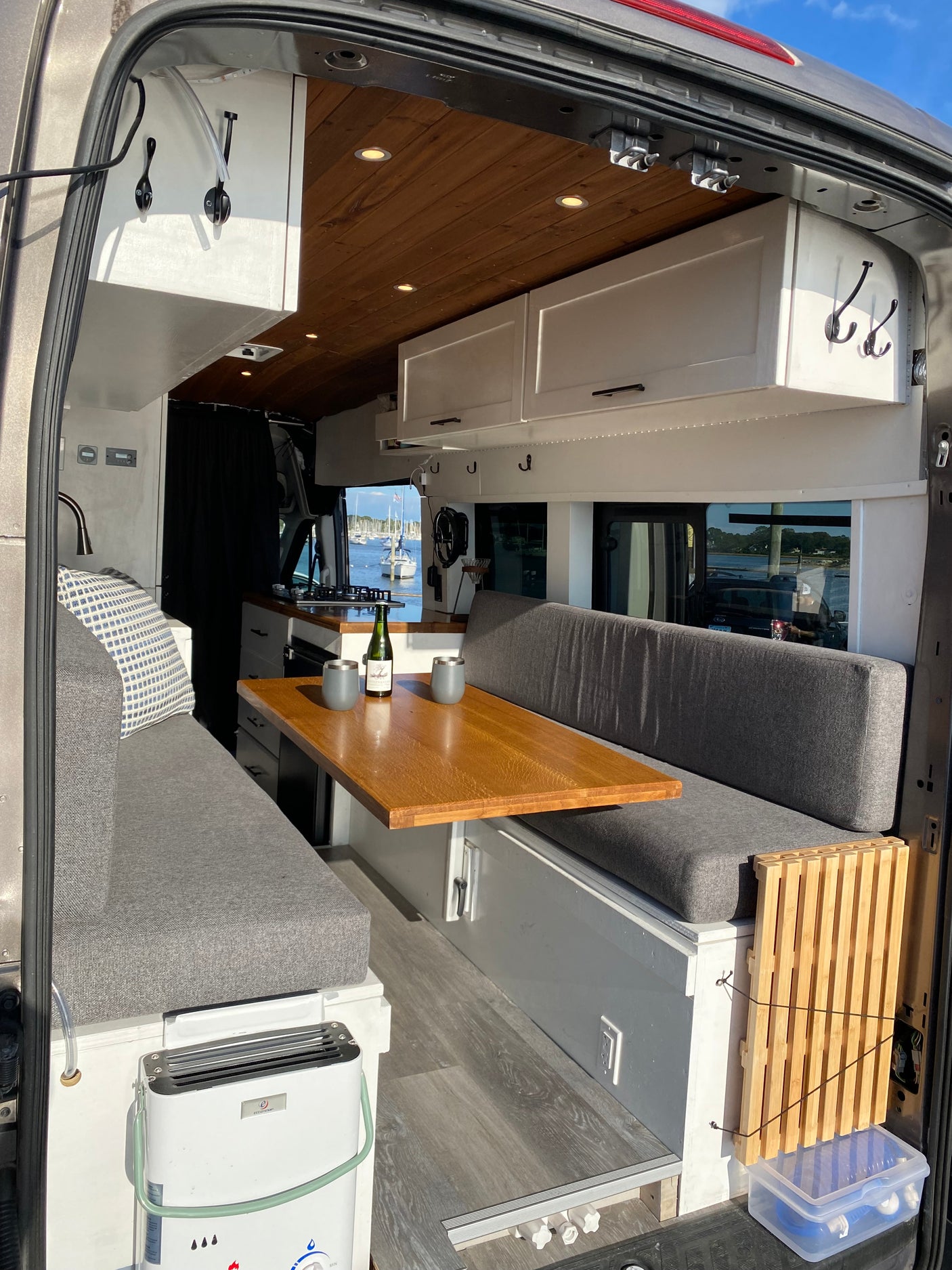and a beautiful marina view.|Cozy RV rental interior with bed & pillows