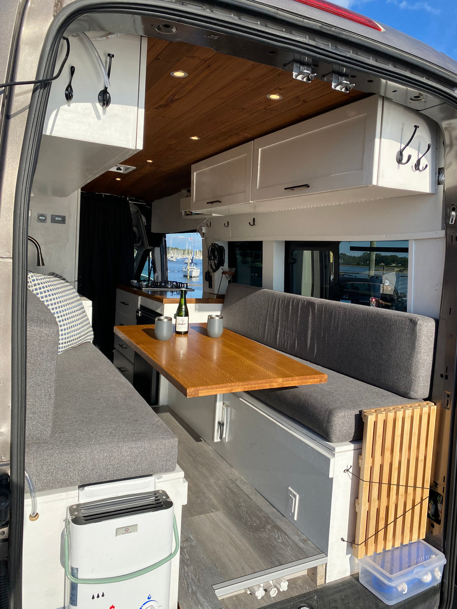 and a beautiful marina view.|Cozy RV rental interior with bed & pillows