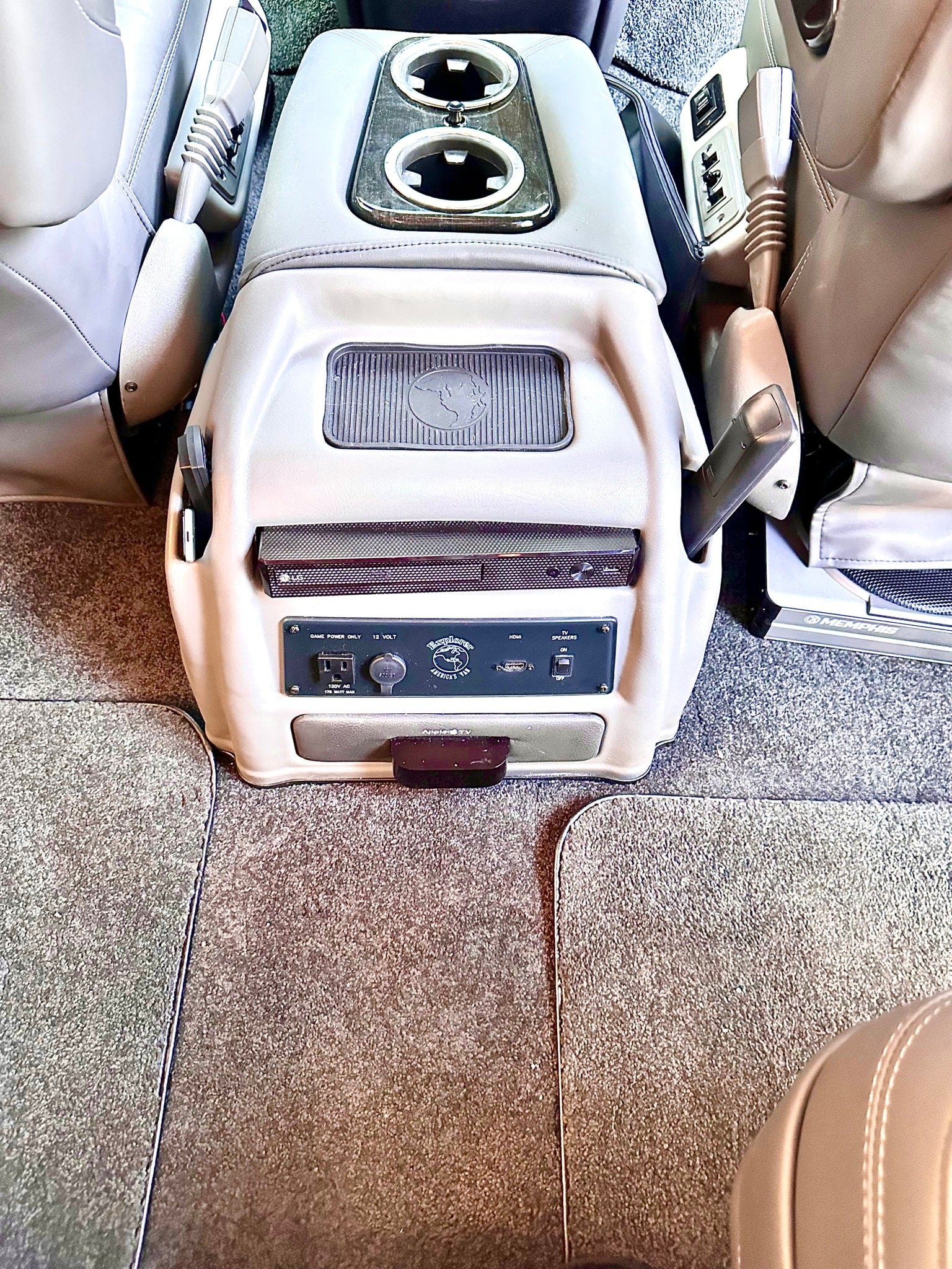 and bright cabin lighting.|Spacious RV rental interior featuring multiple rows of plush leather captain's chairs and large windows.|Spacious RV rental interior featuring black leather captain's chairs